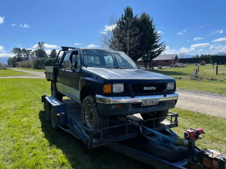 4x4 vehicle on a trailer being removed by Cash For Cars Tauranga, offering free towing and instant cash for all types of vehicles.